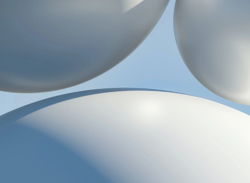 Three gray round 3D like balls over a blue background