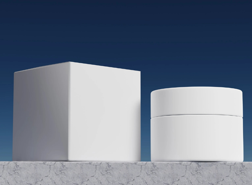 A white cube and cylinder in front of a blue background