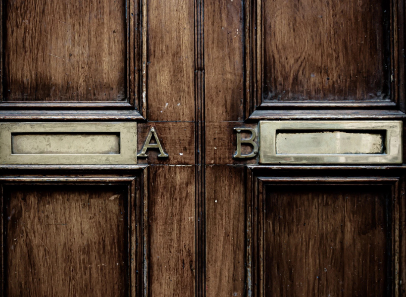 A brown and bonze door with the letter A & B on it