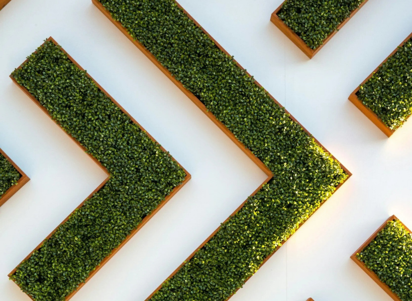 White arrows in front of a grass background