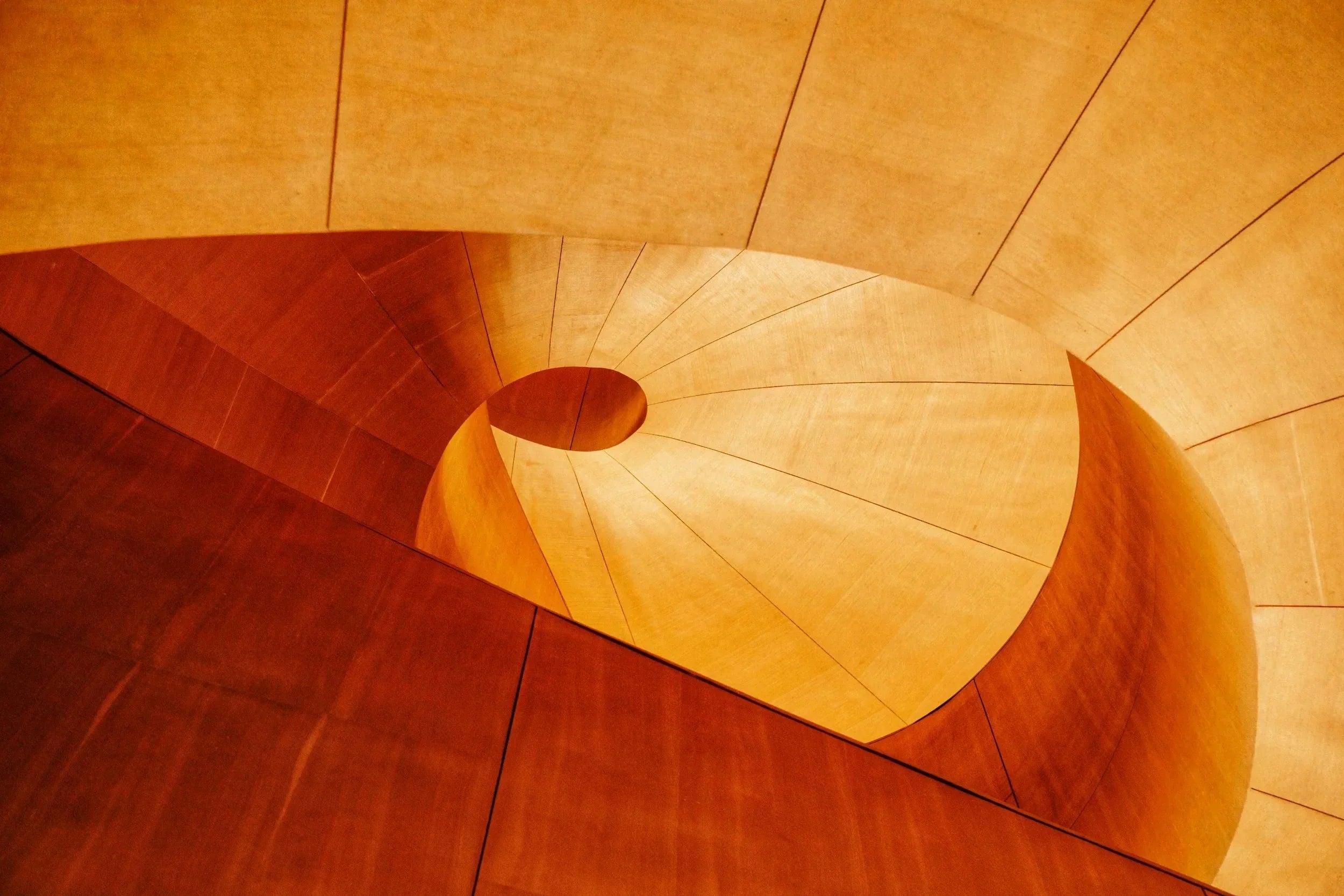 yellow descending circular shaped smooth staircase 