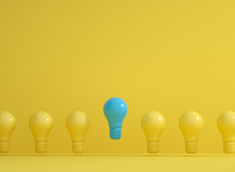 A blue-tinted lightbulb rises higher than the row of yellow lightbulbs it is included in.