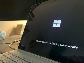 A laptop with the Microsoft log on the screen.